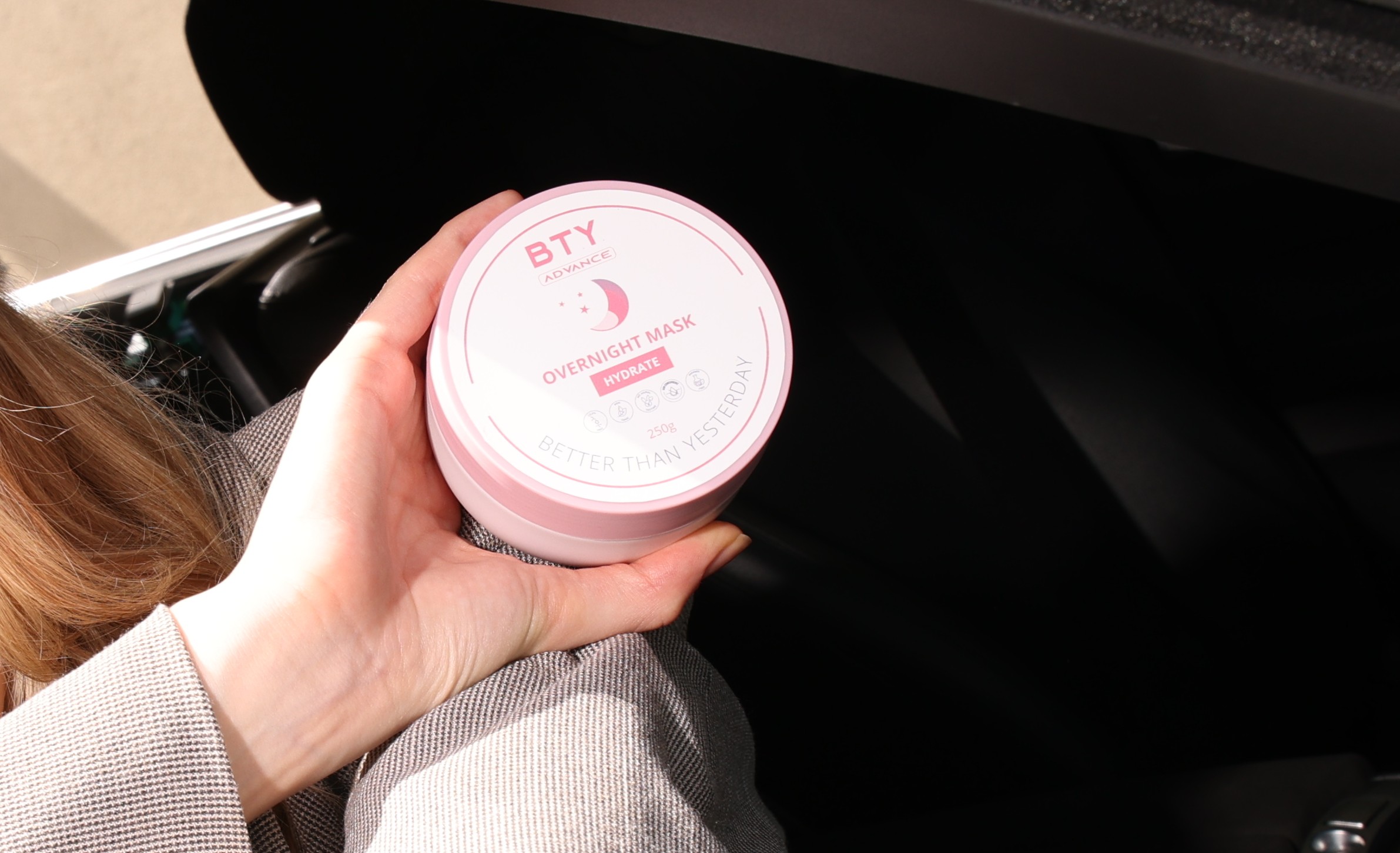 Woman holding BTY Advance Overnight Mask for hyperpigmentation from scars
